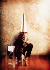 Dunce Holding Paper Money ca. 2001